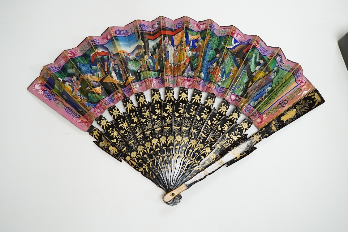Four 19th century Chinese gilt-decorated black lacquer fans with figure painted leaves, two cased, largest 41cm